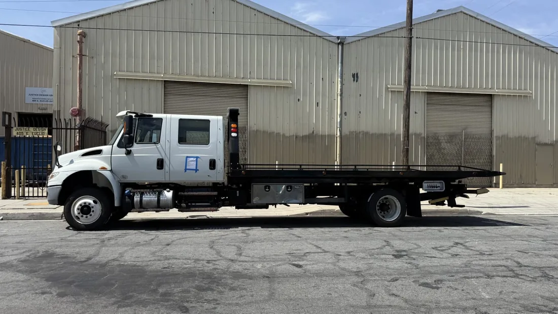 USA-style flatbed carrier tow truck
