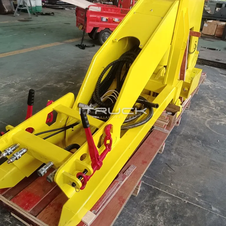 Yellow fifth wheel wrecker frame with hydraulic lines on a pallet