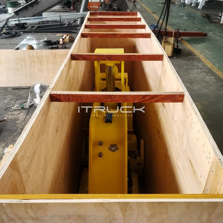 Yellow fifth wheel wrecker packed in an open wooden crate