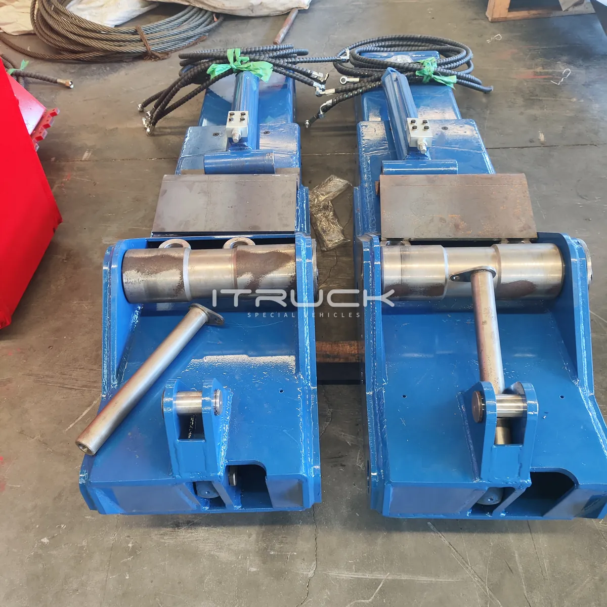 Pair of blue mounting blocks with pivot pins and hoses
