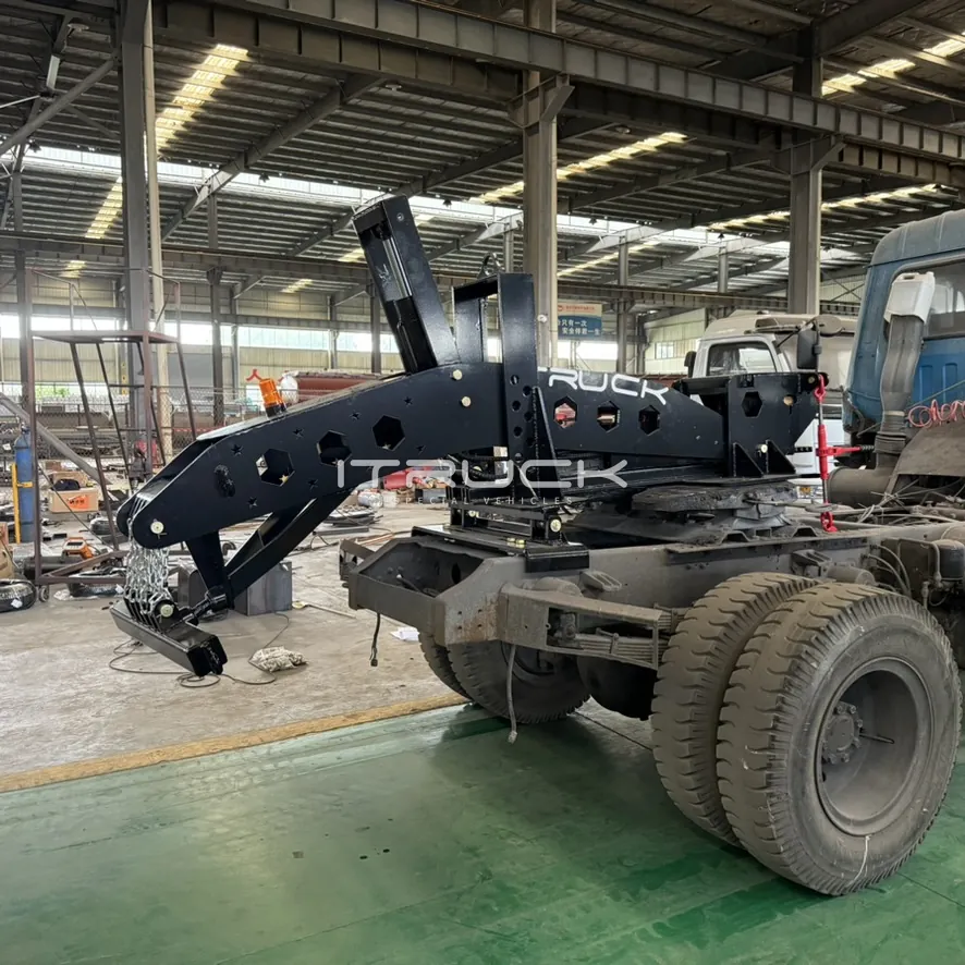 Black fifth wheel wrecker coupled to a truck, underlift lowered