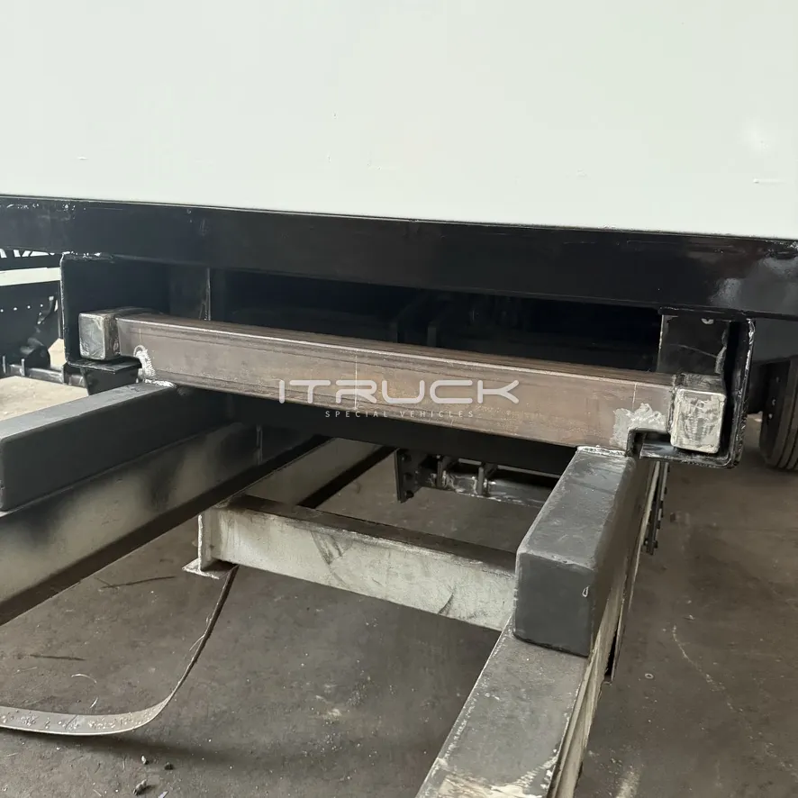 Wheel lift boom in its housing under the tray