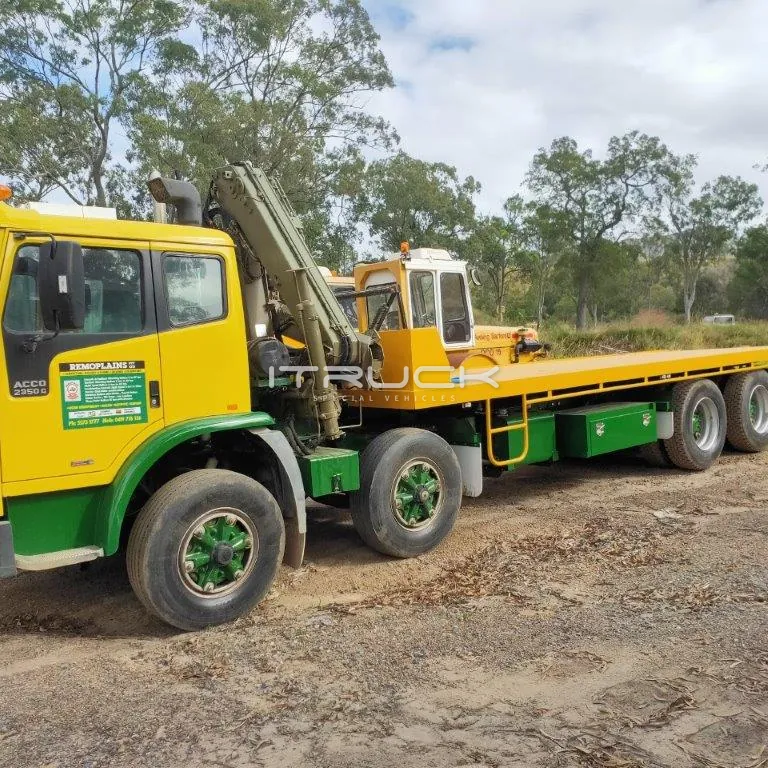 Heavy tilt tray with crane on an 8x4 chassis in service