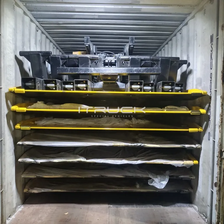 Decks stacked flat with a subframe on top in a container