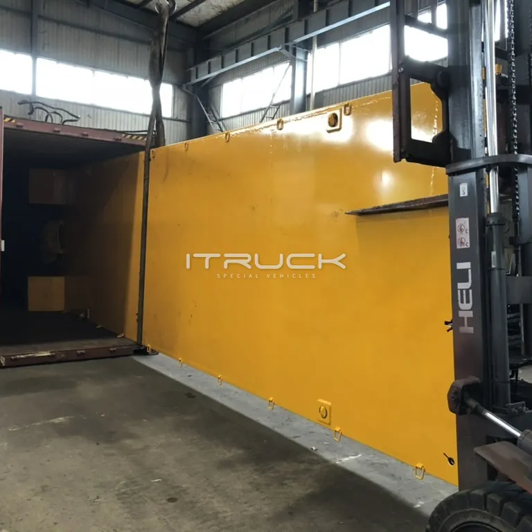 Flatbed deck loaded into a container by forklift