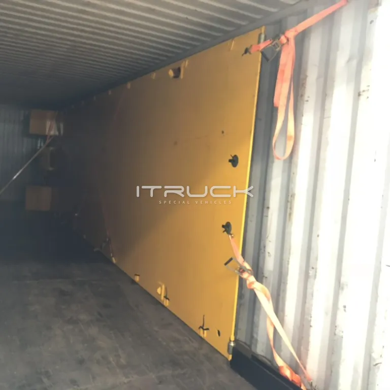 Flatbed deck strapped upright inside a container