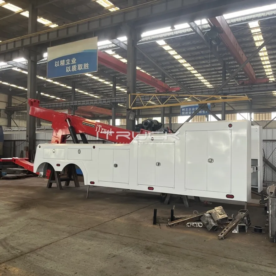 Long white tandem-axle wrecker body with full-length toolboxes