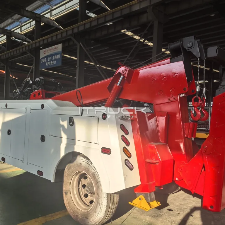Rear quarter of white and red wrecker body with boom stowed
