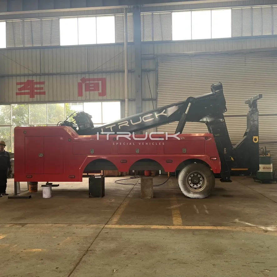 Side view of red wrecker body with black boom on chassis