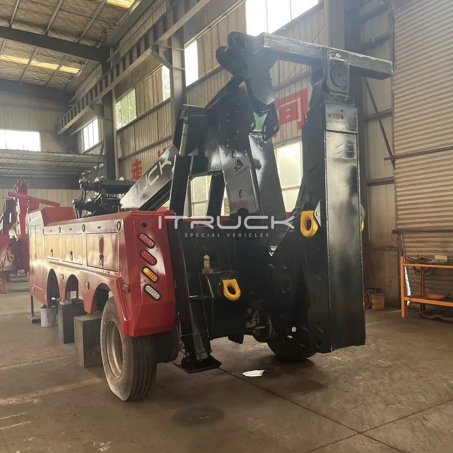 Rear view of red and black wrecker with underlift folded