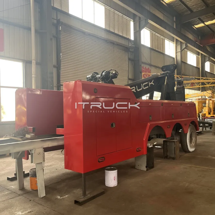 Red wrecker body side toolboxes and tandem wheel arches