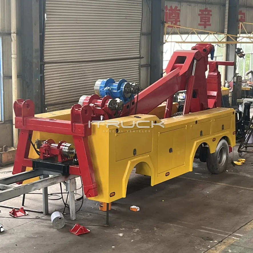 Yellow body with red boom and twin winches during assembly