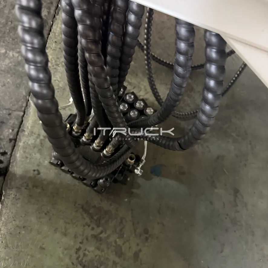 Hydraulic hoses in protective sleeves under the body