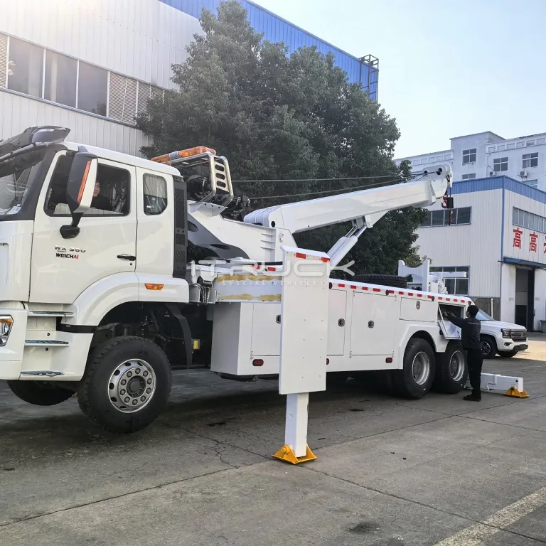 Rotator wrecker side view with boom stowed and outriggers deployed