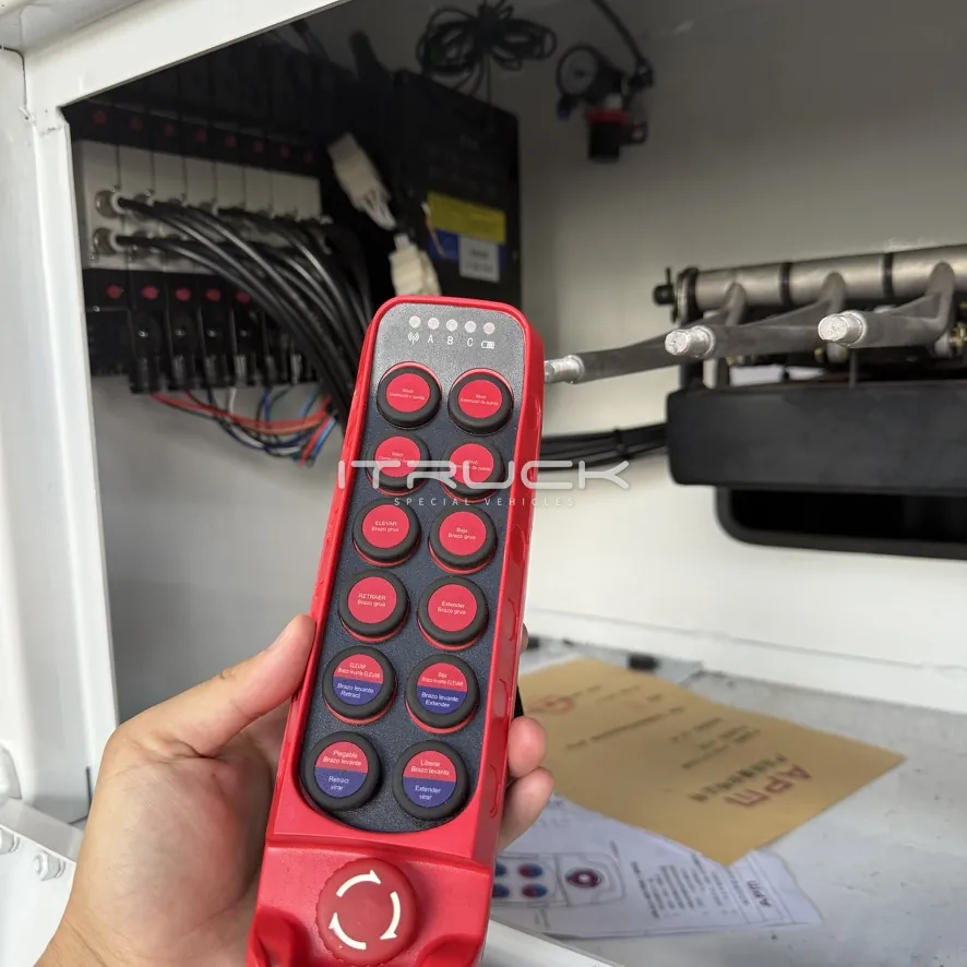Push-button radio remote control held in front of the control station
