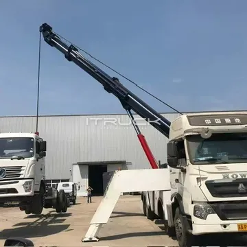Rotator with boom extended holding a truck chassis, front view