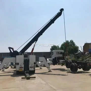 Rear view of rotator lifting a truck chassis with outriggers spread