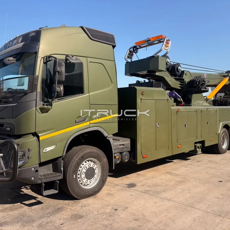 Green turret slide rotator wrecker on a four-axle chassis